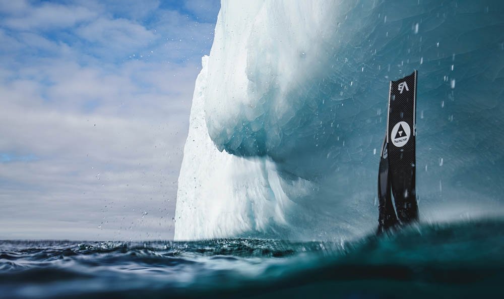 Freediver wearing Alchemy V3 Carbon Fiber Bifins next to a storm, in Silver