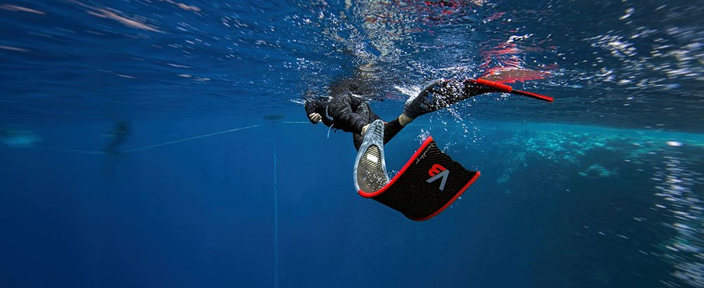 Freediver wearing Alchemy V3 Carbon Fiber Bifins, in Red/Red