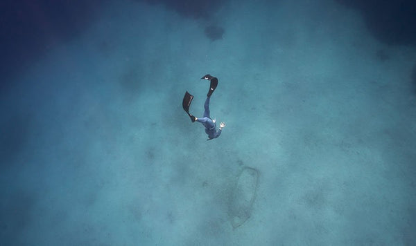 Freediver diving to a wreck in Alchemy V3-30 Carbon Fiber Bifins