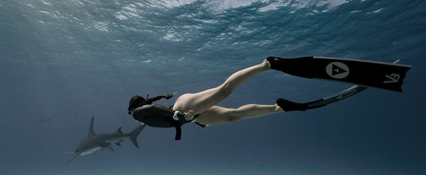Freediver diving with a shark in Alchemy V3-30 Carbon Fiber Bifins, in Silver